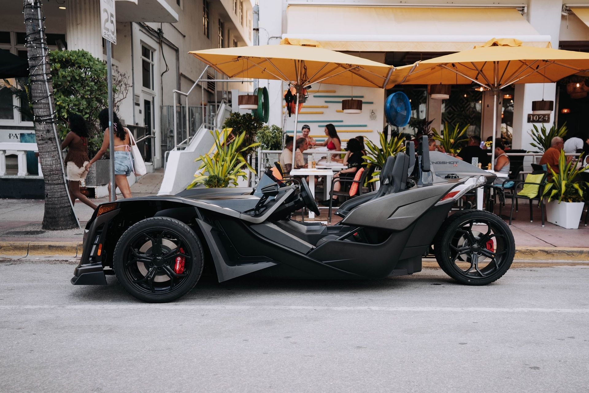A Polaris Slingshot parked outside a cafe on Ocean Drive, Miami Beach