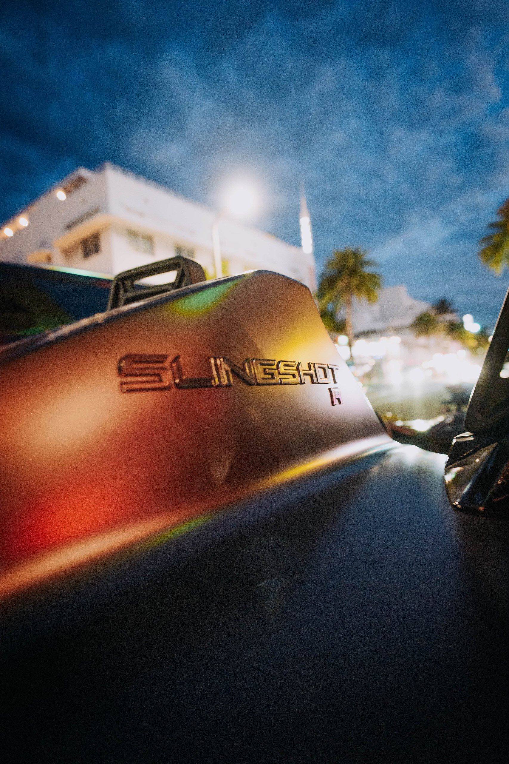 Close-up of the Slingshot badge on the bodywork at sunset