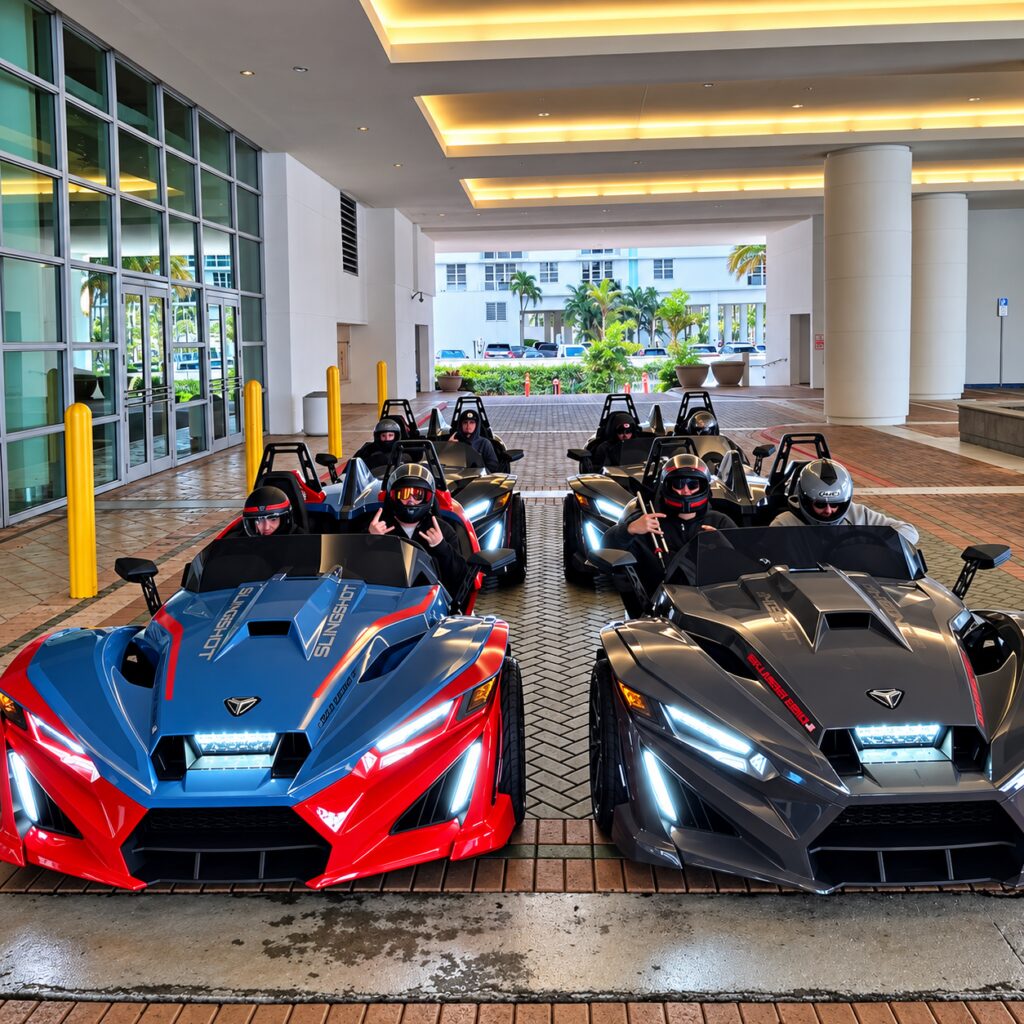 Red and black Polaris Slingshots parked in front of a glass building